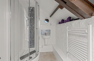 Bathroom with shower cubicle, washbasin and wc